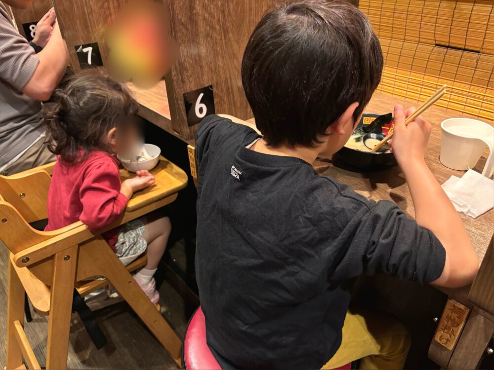 「一蘭」でラーメンを食べる子どもたち